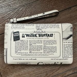 NWT | COACH Large Corner Zip Wristlet
With Newspaper Print | Water Buffalo